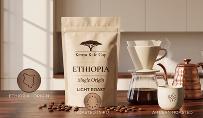 Kenya Kafe Cup Ethiopia Single Origin Light Roast coffee bag displayed on a wooden counter beside a V60 pour‑over setup, steaming cup, and copper kettle. Warm morning light and minimalist kitchen setting emphasizing artisan roasting and origin authenticity.